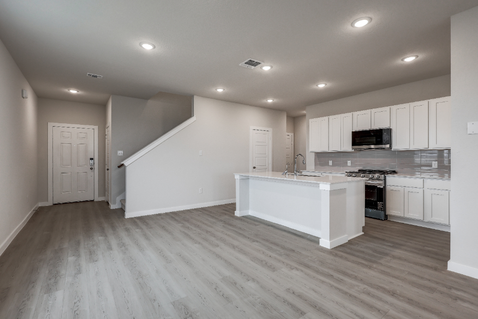 A kitchen with white cabinets.