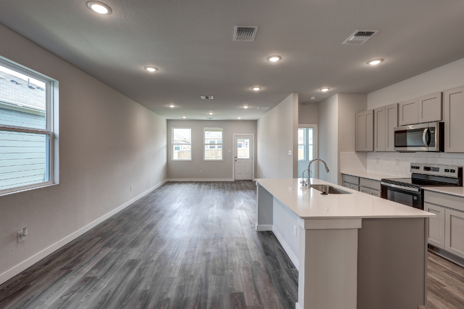 A kitchen with white cabinets.