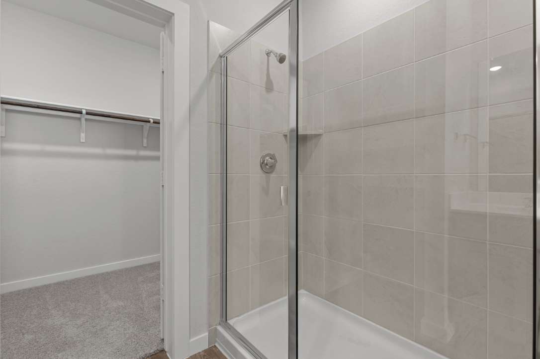 A shower with a glass door.