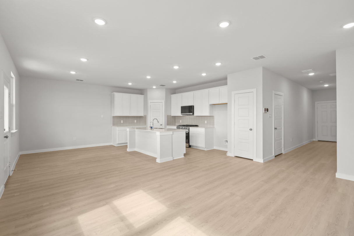 A large kitchen with white cabinets.