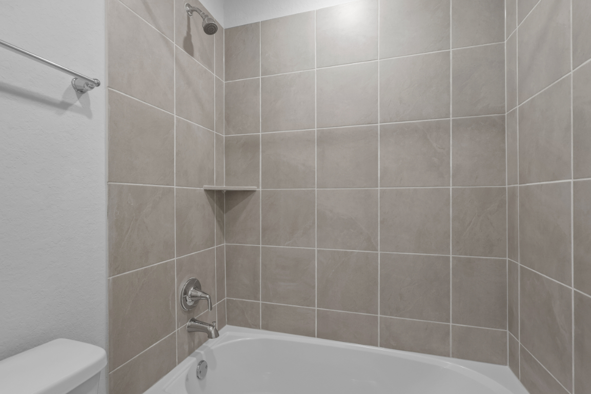 A bathtub in a bathroom.