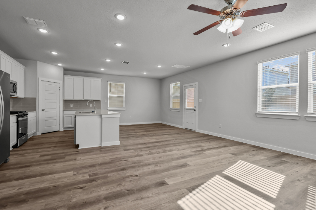 A kitchen with white cabinets.