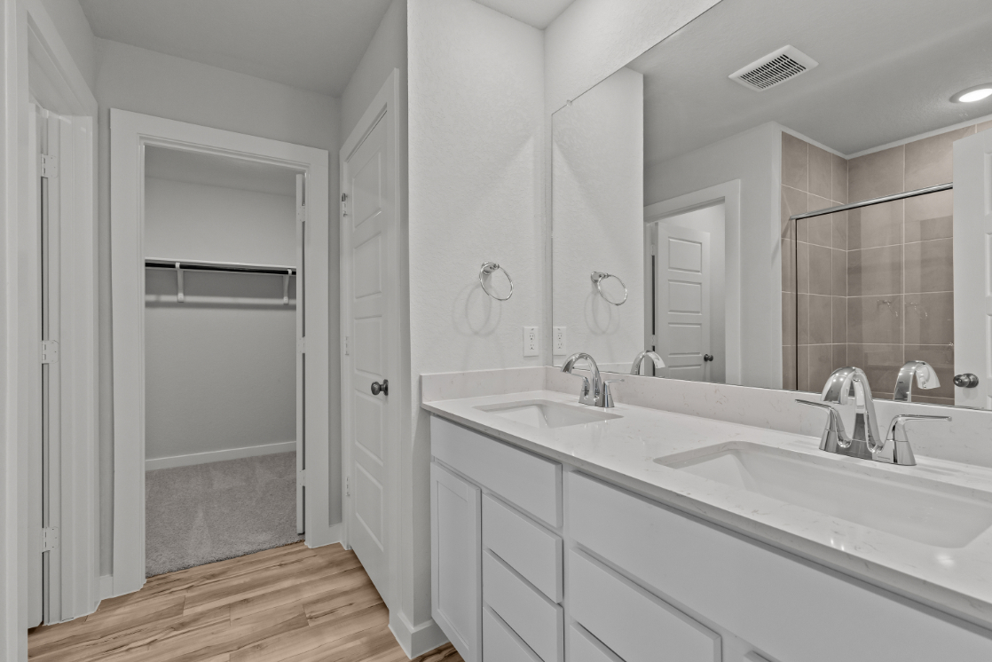 A bathroom with a tub sink and shower.