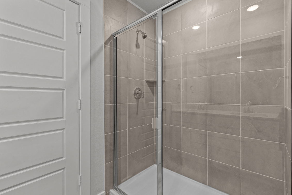 A shower with a glass door.