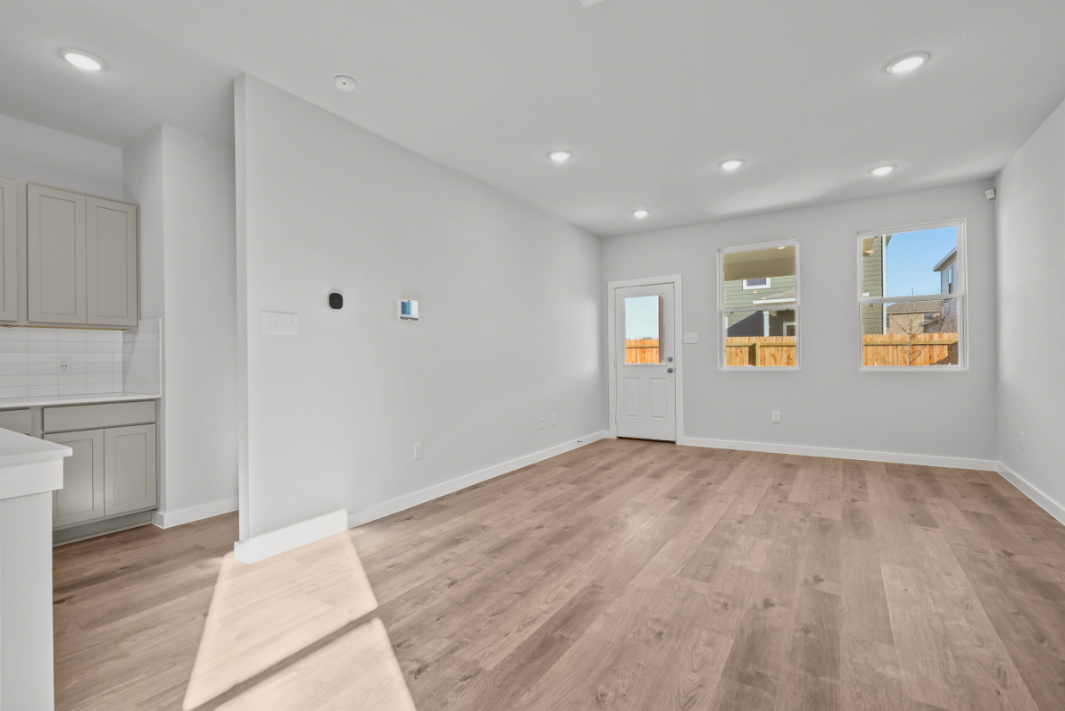 A room with white walls and a wood floor.