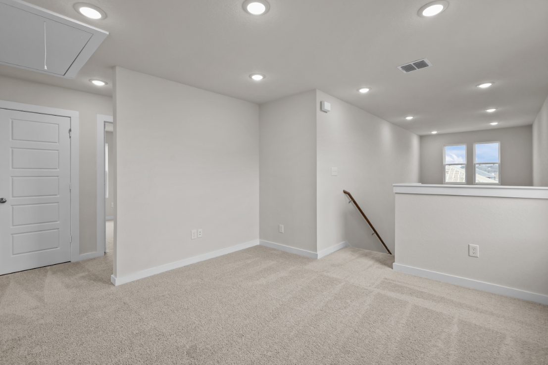 A room with white walls and a wood ladder.