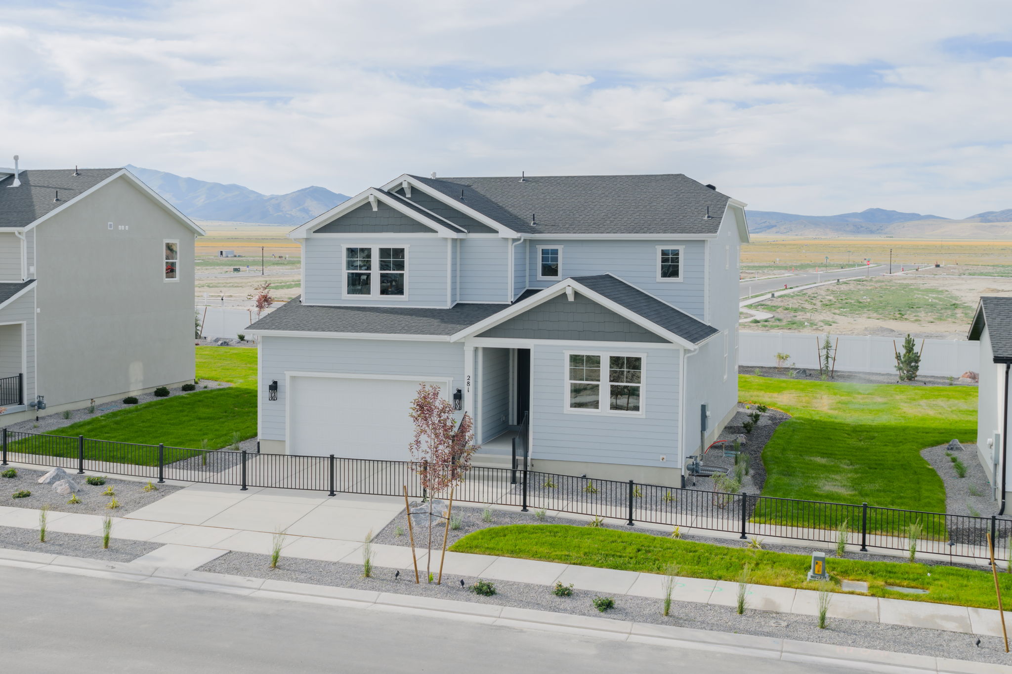 A white house with a fence around it.