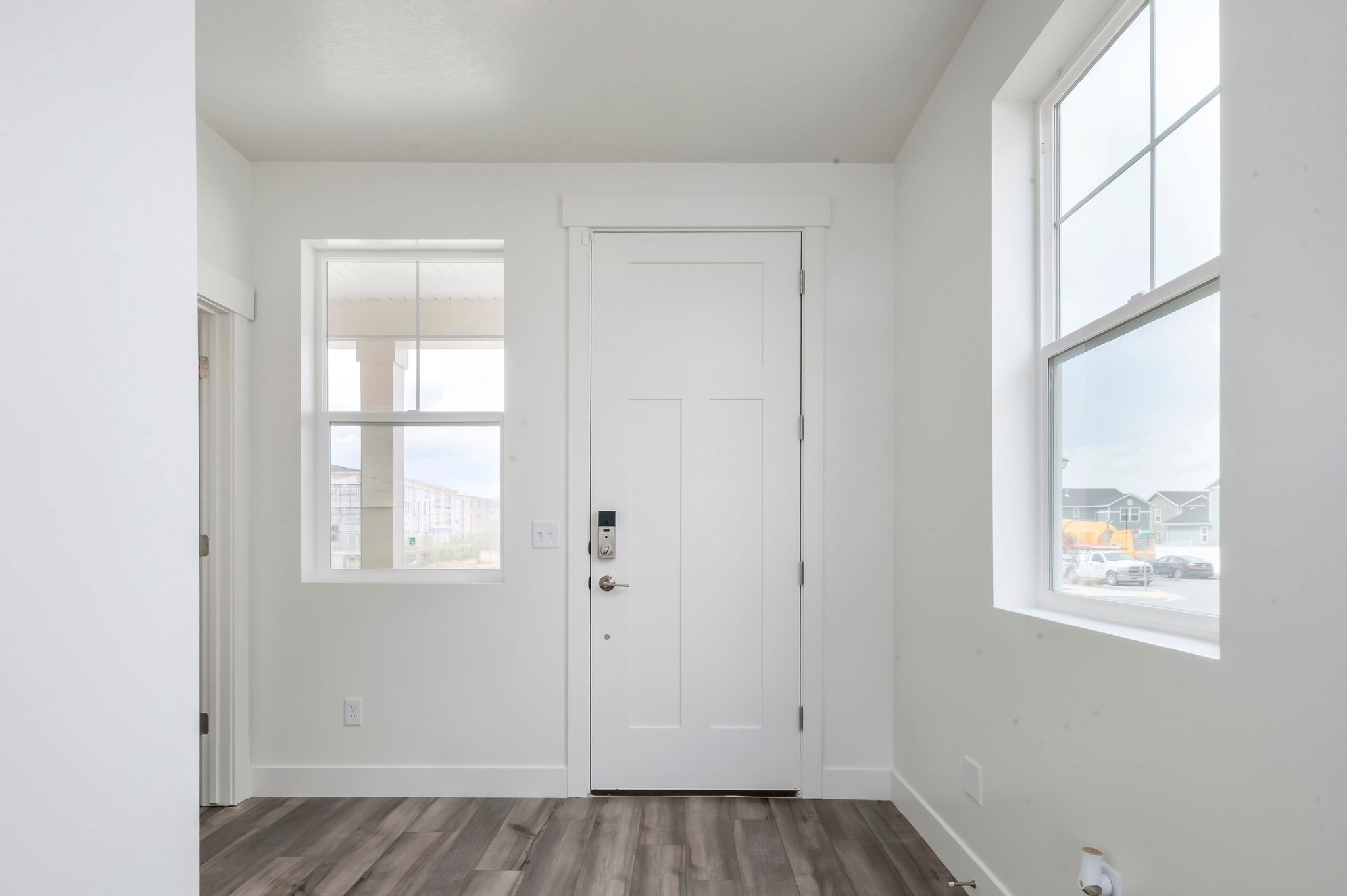 A room with a white door and windows.