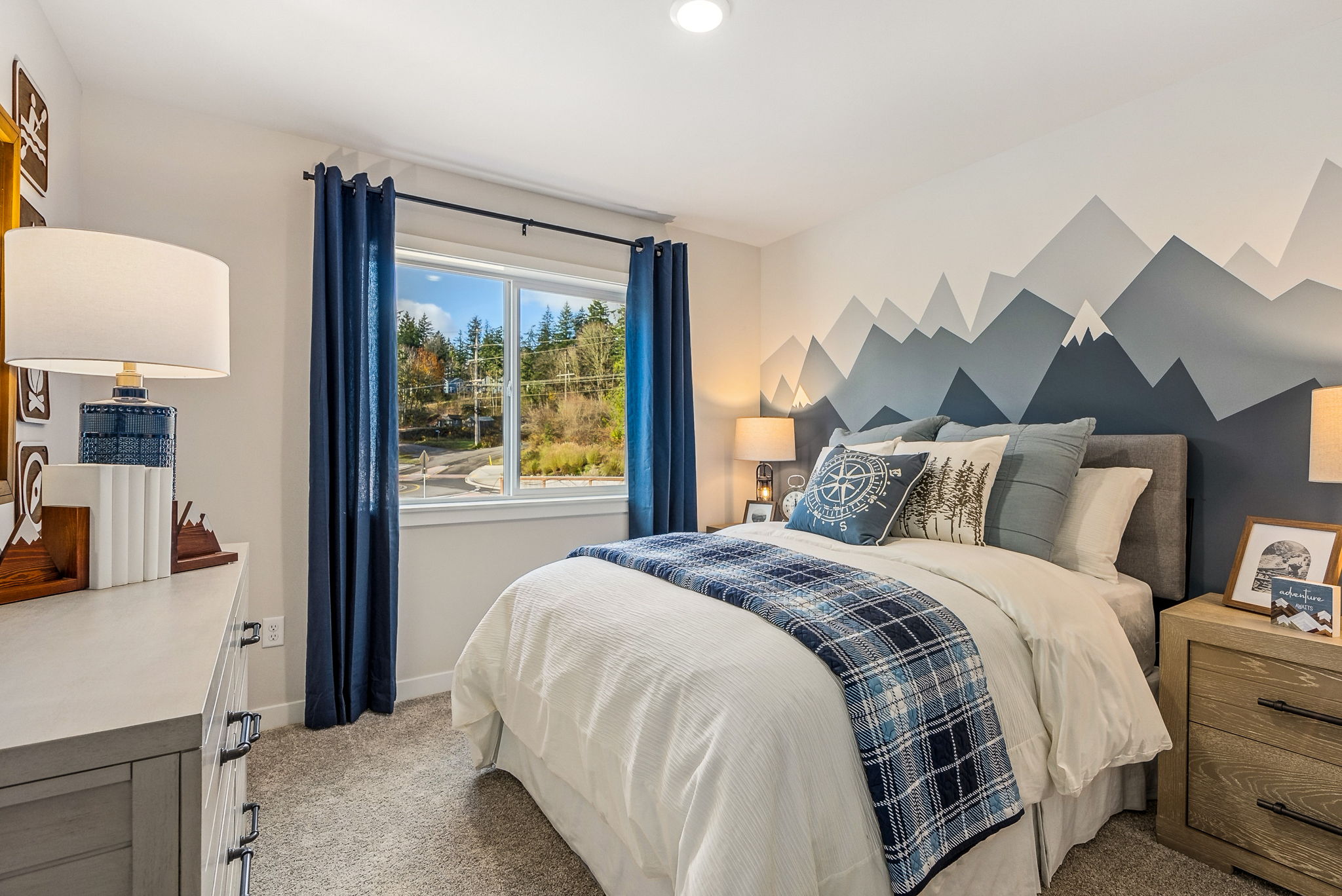 A bedroom with a large window.