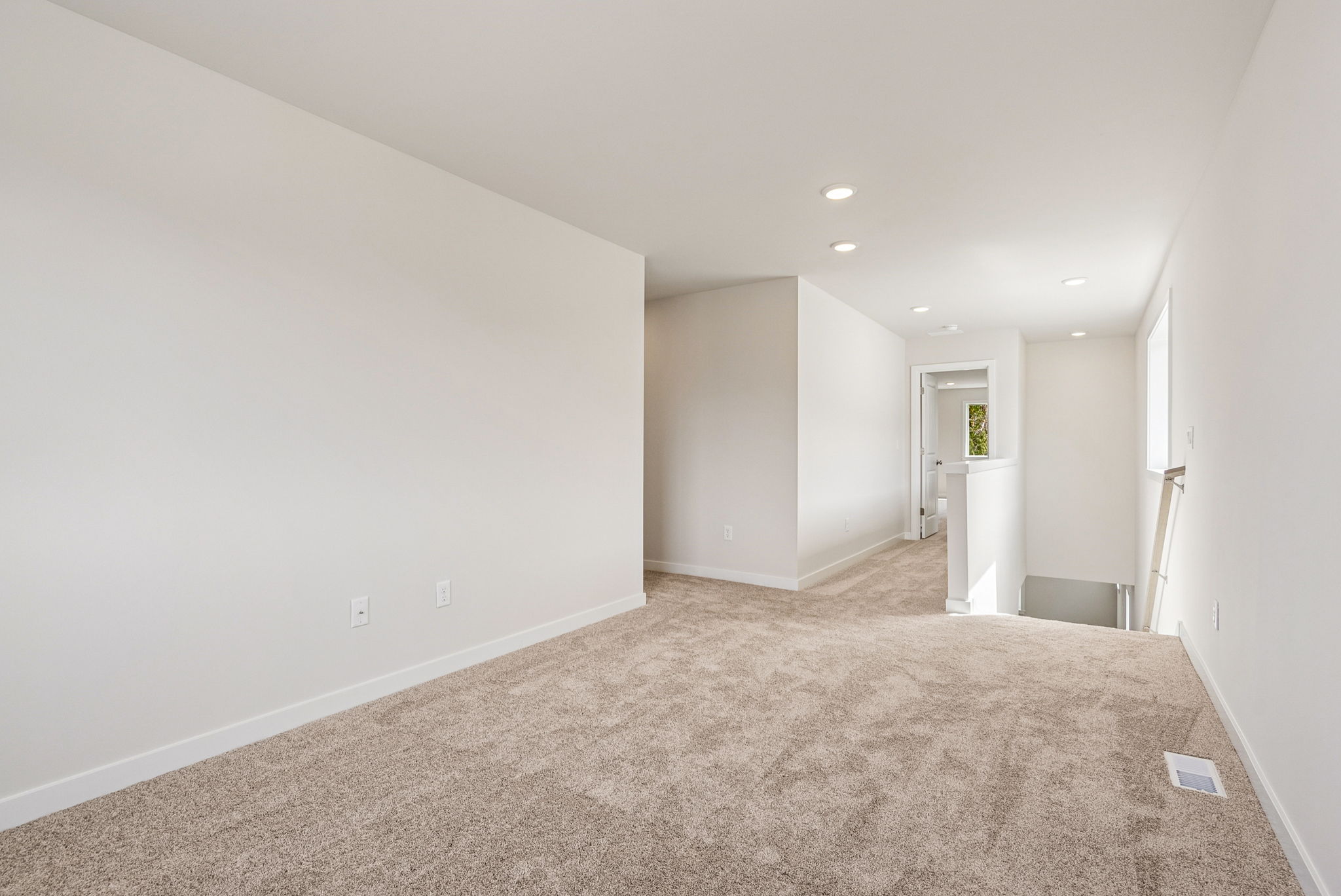 A long hallway with white walls.