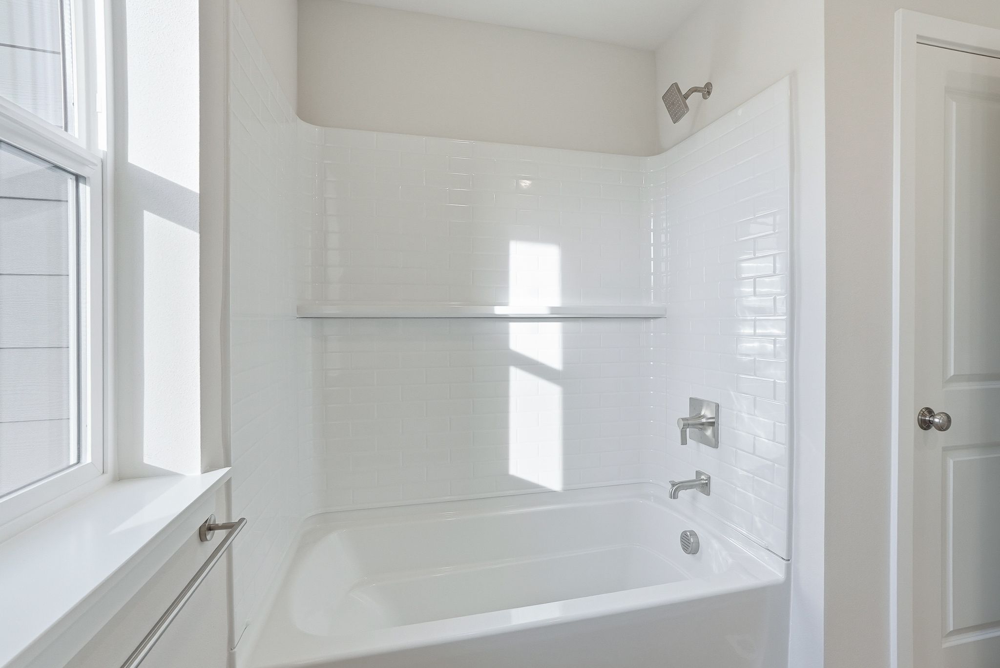 A bathroom with a bathtub and sink.