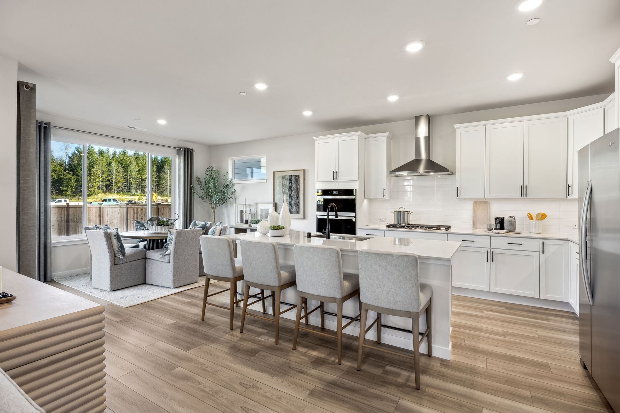 A kitchen with white cabinets.