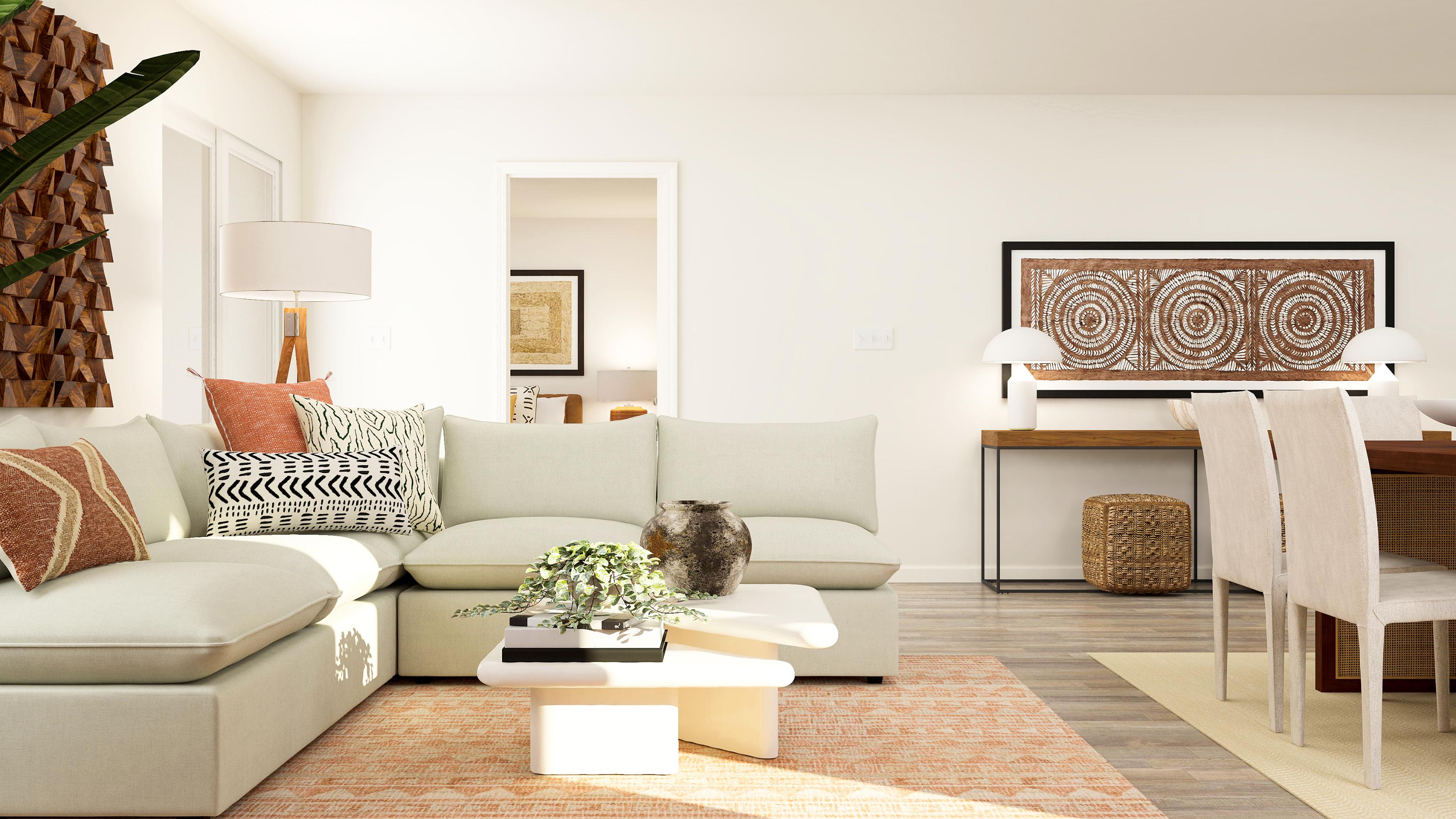 A living room with a white couch and a table.