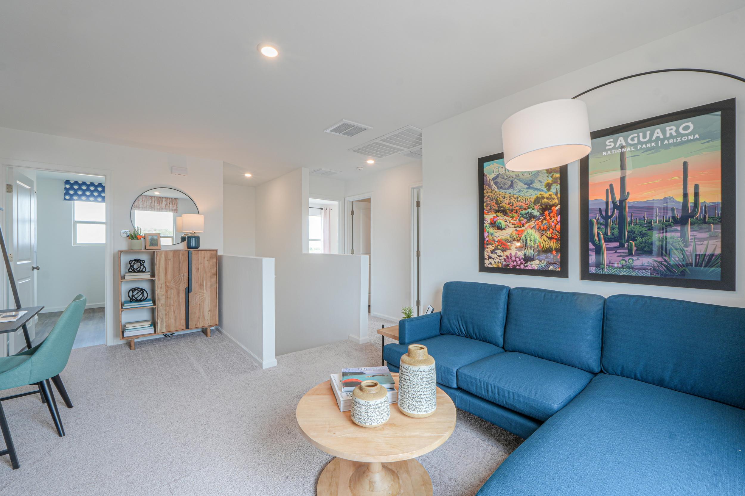 A living room with blue couches.