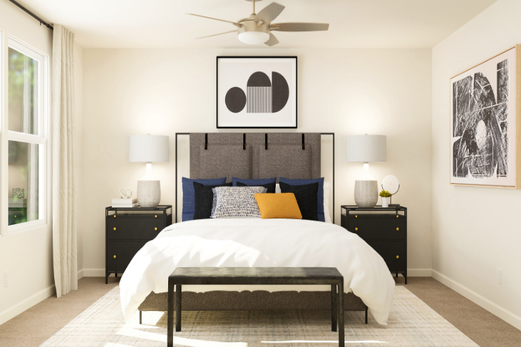 A bedroom with a bed and lamps.