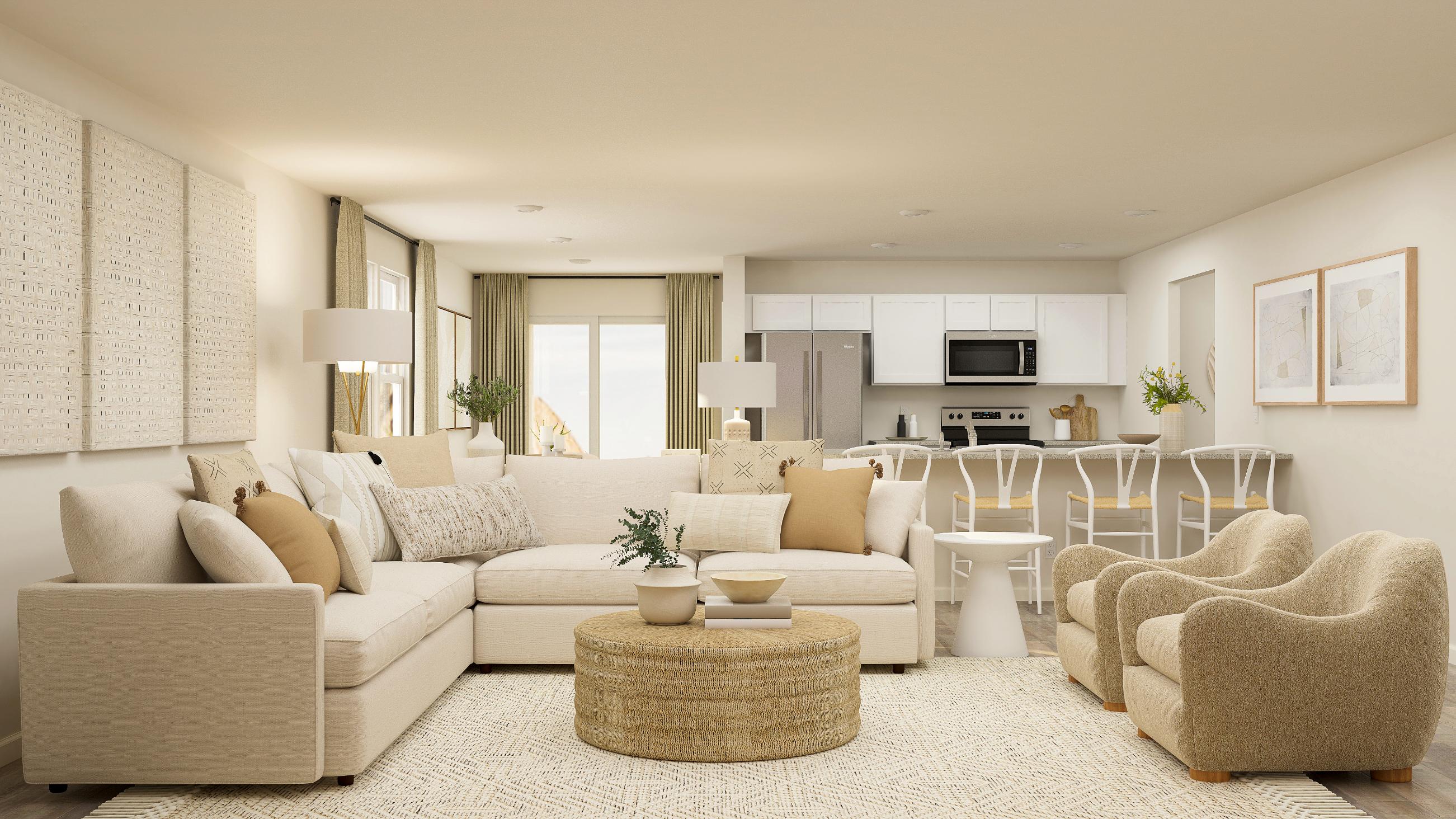 A living room with a large white couch and a table.