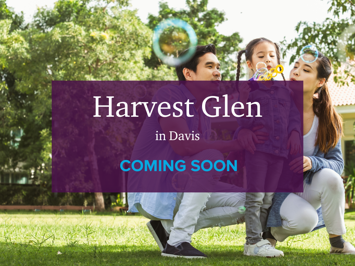 A group of people holding a purple sign.