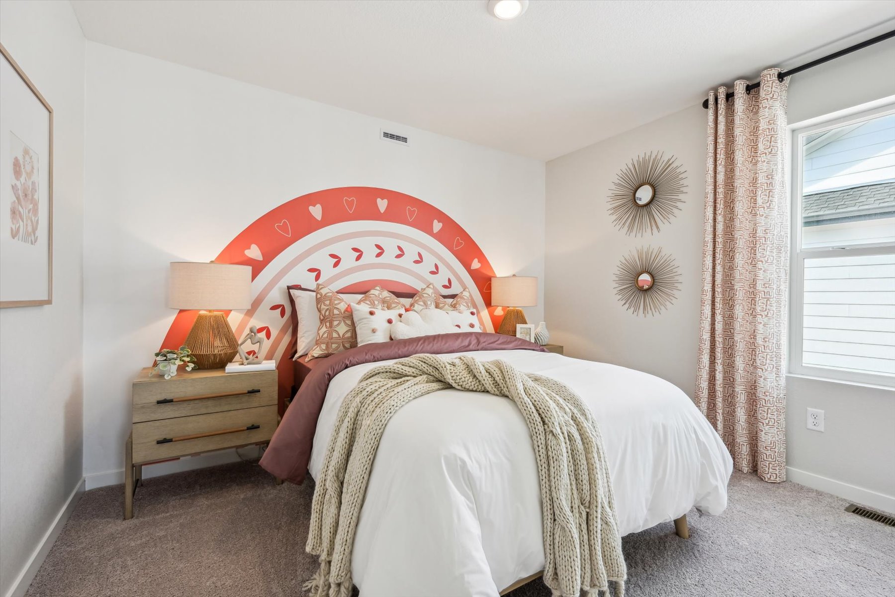 A bedroom with a bed and lamps.